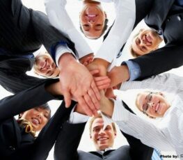 A image of a group putting their hands together.