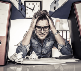 An image of a frustrated man having trouble solving a problem.