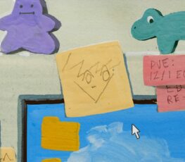 Personal decorations and post-its on a computer in an office.
