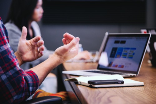 person communicating in work meeting.